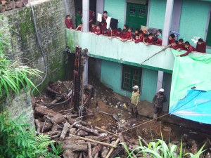 Young residential school children watch with great anticipation as the second process of boring into earth produces gushing flow of water at nearly 400 feet depth!